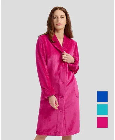 Woman in fuchsia flannel long dressing gown, buttoned and with pockets for winter