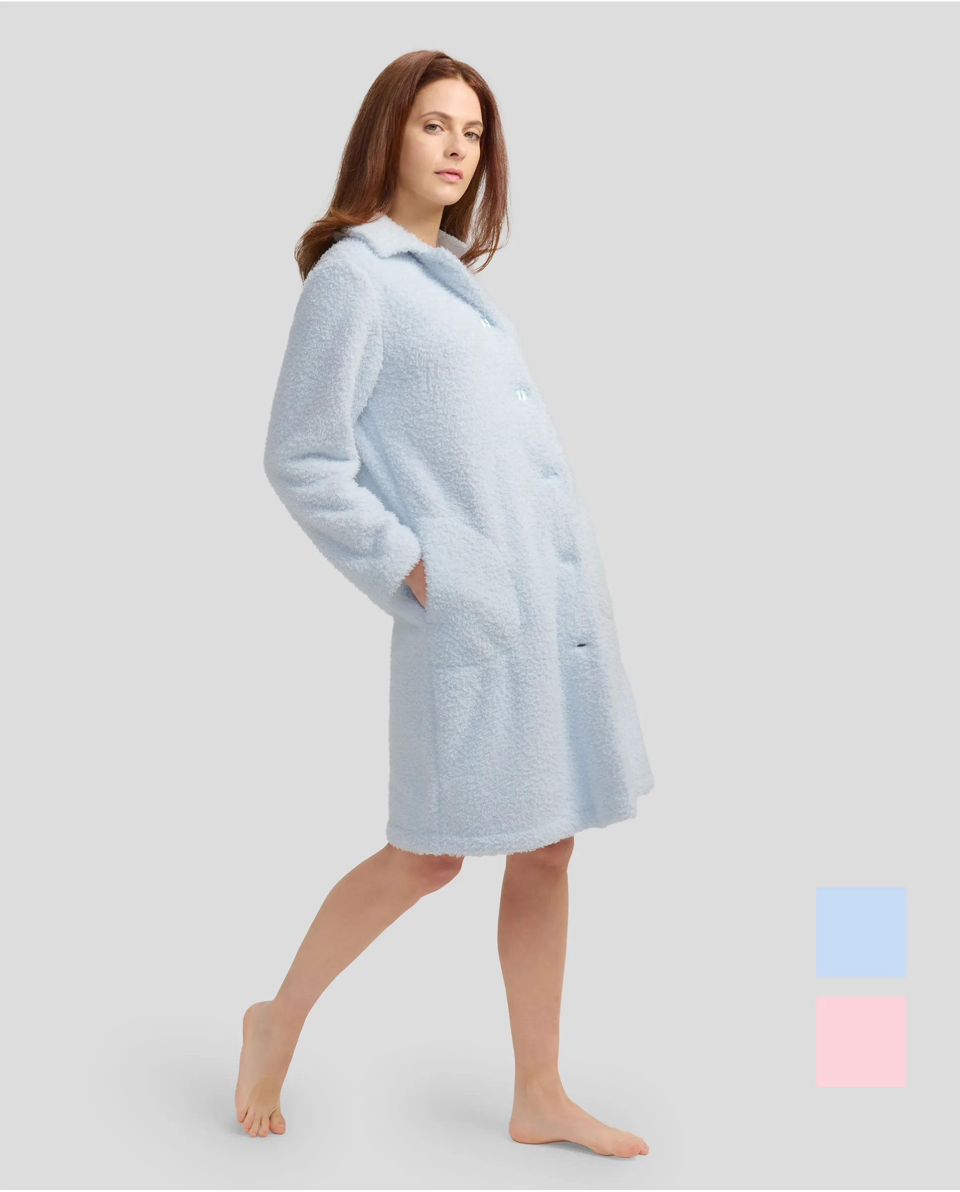 Woman with long sky blue sheepskin coat with buttoned buttons and pockets