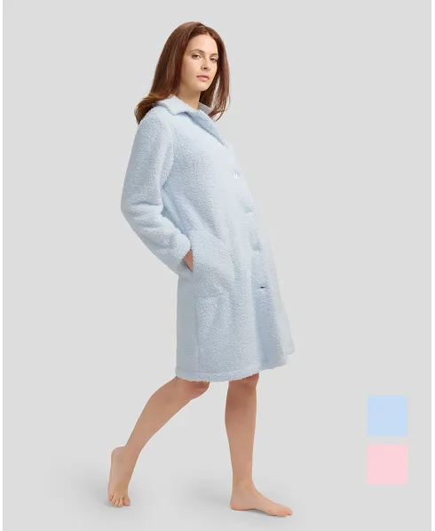 Woman with long sky blue sheepskin coat with buttoned buttons and pockets