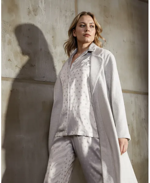 Woman wears grey fleecy long dressing gown with matching pyjamas