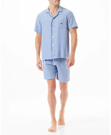 A man wearing a blue and white striped open short pyjama set.