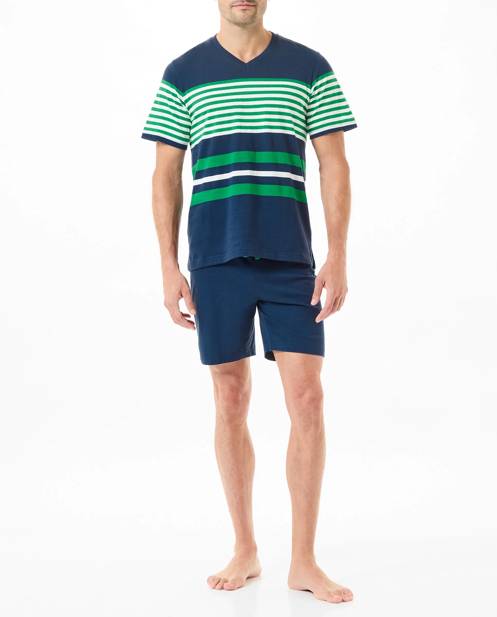 A man wearing summer pyjamas with a navy striped T-shirt and shorts.