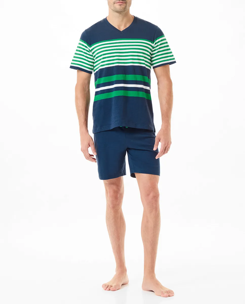 A man wearing summer pyjamas with a navy striped T-shirt and shorts.