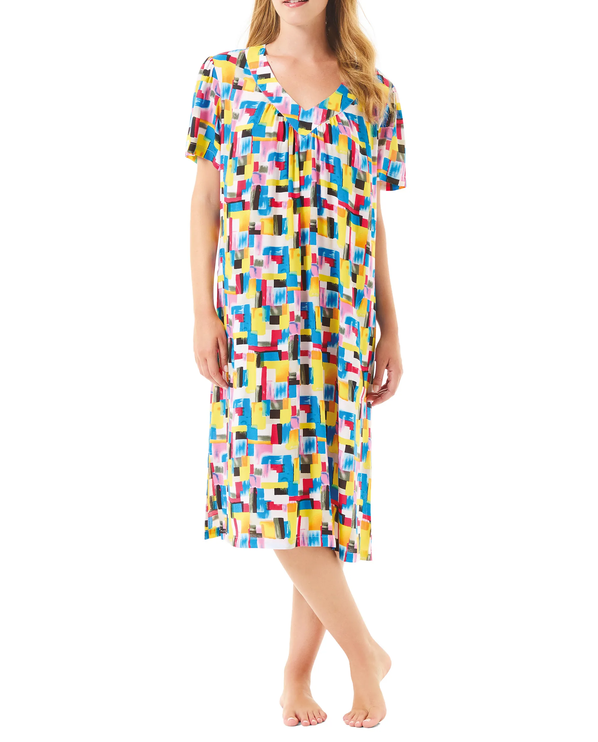 Woman wears short-sleeved summer dress with colourful geometric print