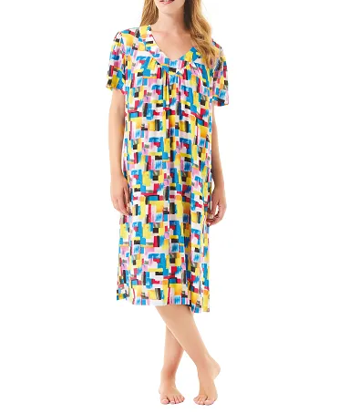 Woman wears short-sleeved summer dress with colourful geometric print