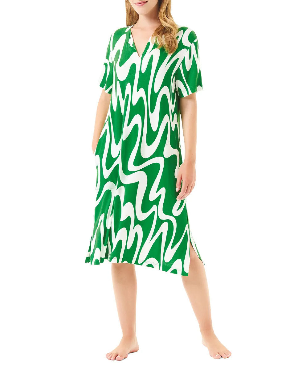 Woman wearing summer swim dress with green wave print and short sleeves