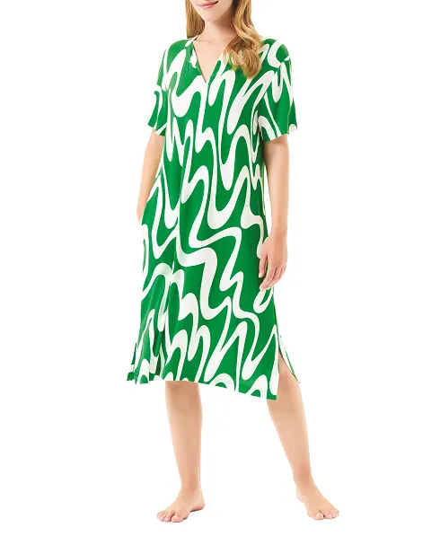 Woman wearing summer swim dress with green wave print and short sleeves