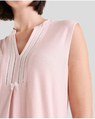 Woman wears sleeveless lingerie summer nightdress in pink ribbed lingerie for summer with open neckline and back