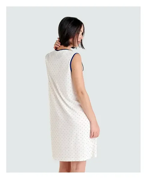 Rear view of white sleeveless nightdress with navy dots and dark blue trim.