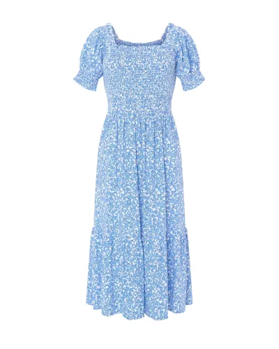 Woman in long blue flowered dress with short sleeves, honeycomb top and square neckline