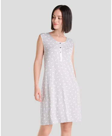 Woman in elegant grey sleeveless knee-length nightdress with subtle white feather print and open collar with silver buttons.