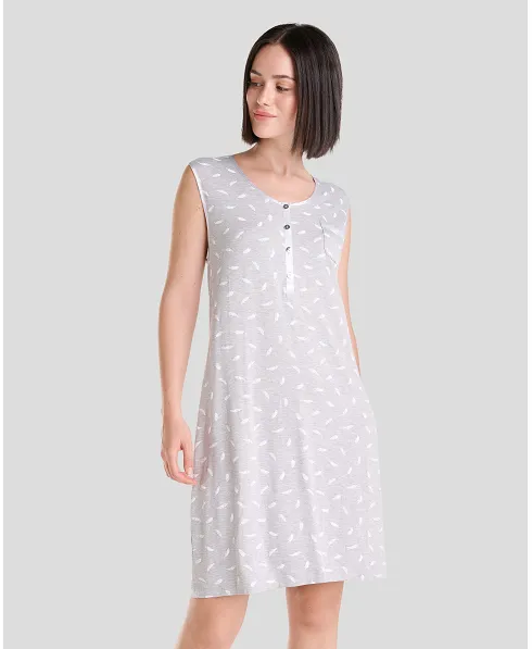 Woman in elegant grey sleeveless knee-length nightdress with subtle white feather print and open collar with silver buttons.