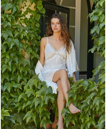 Woman wears matching set of lingerie strapless nightdress and matching satin cross dressing gown