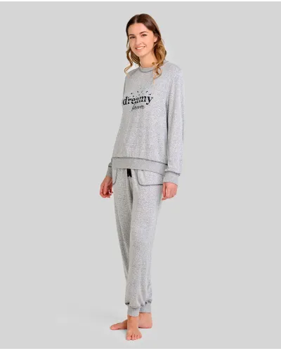 Woman wearing grey long-sleeved pyjamas with "dreamy" embroidery and elasticated cuffs
