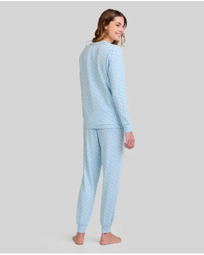 Woman wearing long-sleeved pyjamas for winter in sky blue with grey polka dots and decorative pocket