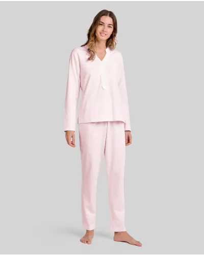 Woman wearing pale pink long nightdress pyjamas with open neckline, lace trim and bow