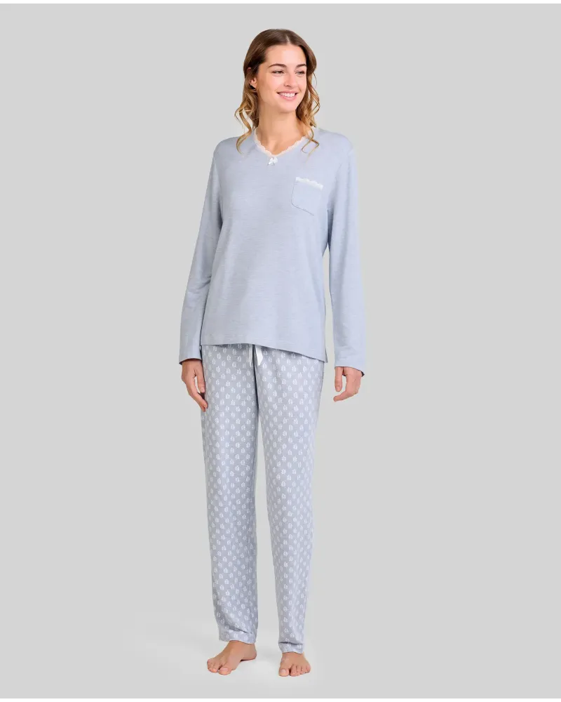 Woman wearing steel blue long-sleeved winter pyjamas with leaf-print trousers