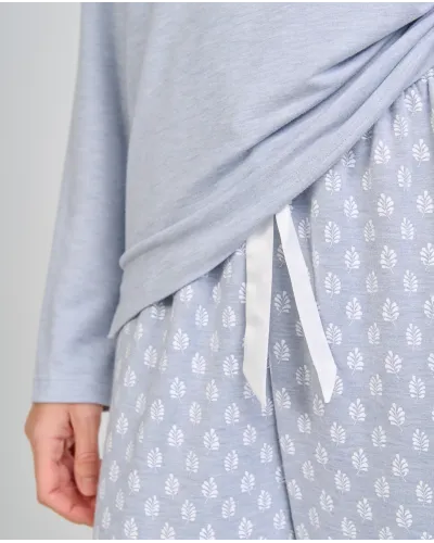 Woman wearing steel blue long-sleeved winter pyjamas with leaf-print trousers
