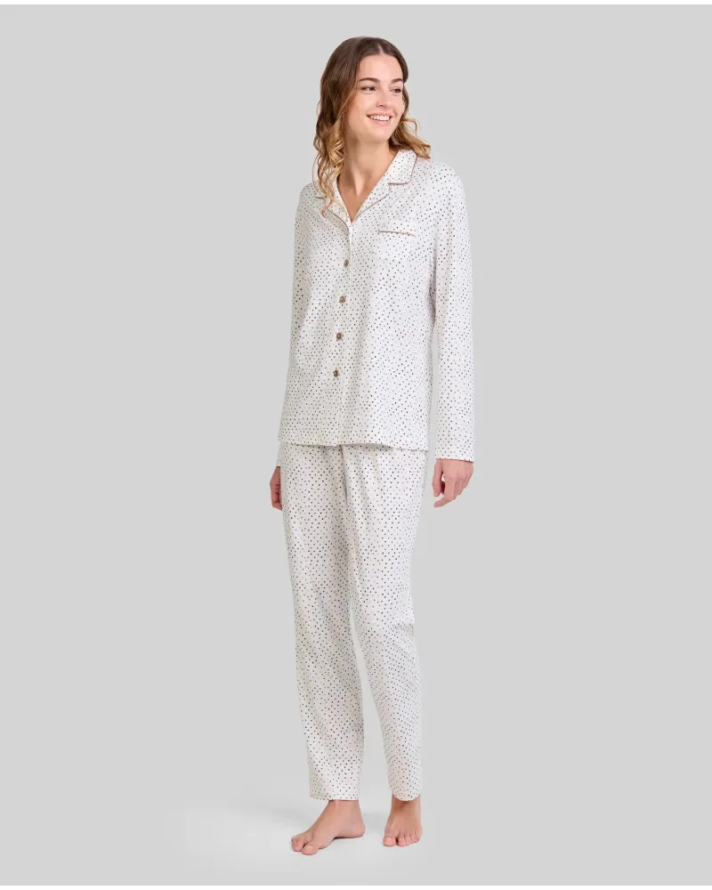Woman wearing long-sleeved button-down pyjama top with circle print