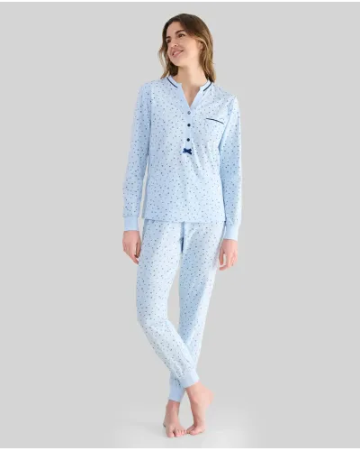 Woman wearing long sky blue winter pyjamas with a floral print, button-up collar and pocket