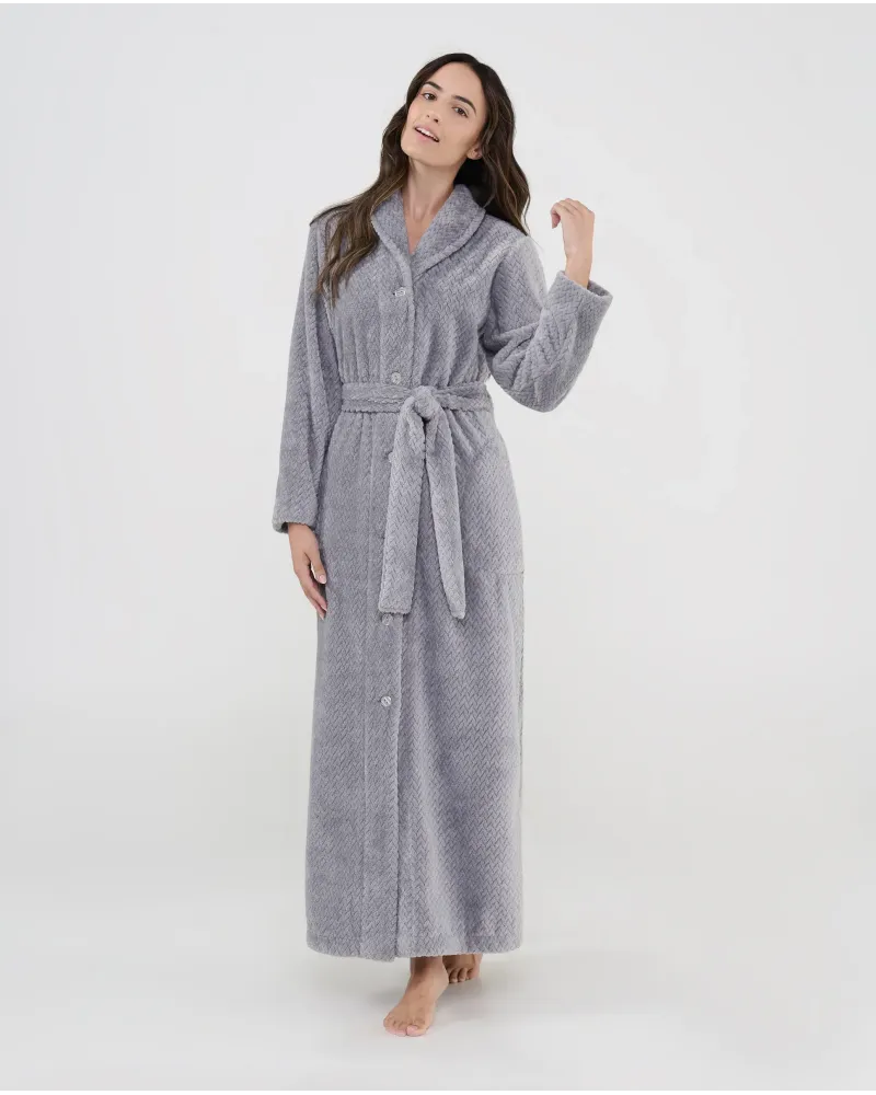 Woman wearing a long grey jacquard robe with buttons, belt and side pockets