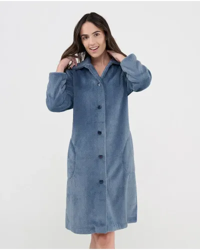 Woman wearing a long, buttoned winter coat in Pacific blue jacquard