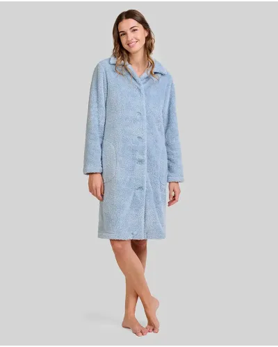 Woman wearing a steel blue buttoned terry cloth robe that reaches to the knee and has large side pockets.