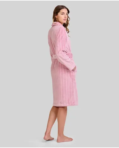 Woman wearing a pink jacquard wrap-around robe with stripes, pockets and a belt.