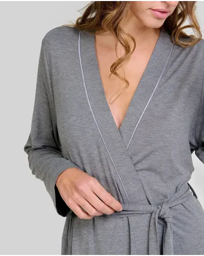 Woman poses in a long grey modal wrap-around robe