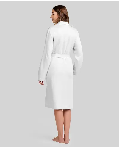 Woman wearing a long ivory lace robe with buttons and a belt