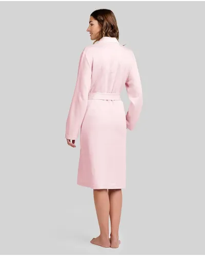 Woman wearing an elegant long pink lingerie robe with buttons and a belt