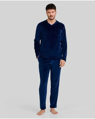 man wearing navy blue velvet pyjama bottoms with a V-neck and side pockets