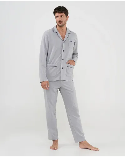 Man wearing light grey long-sleeved pyjamas with bright black trim and front buttons, ideal for sleeping.