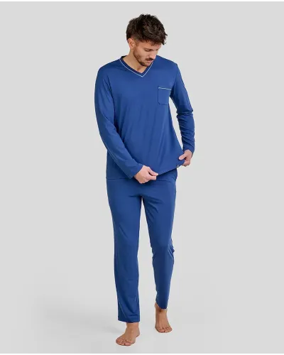 Man wearing long blue modal winter pyjamas with a V-neck and side pockets.
