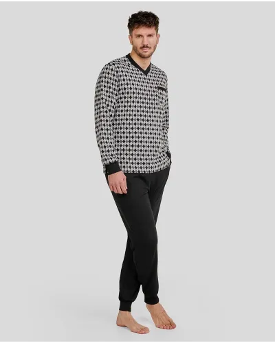 Man wearing long black winter pyjamas with diamond print and elasticated cuffs