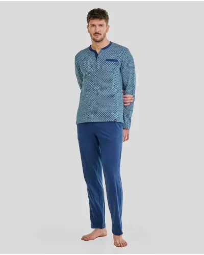 Man wearing blue long-sleeved pyjamas with geometric print, open collar with buttons and long trousers