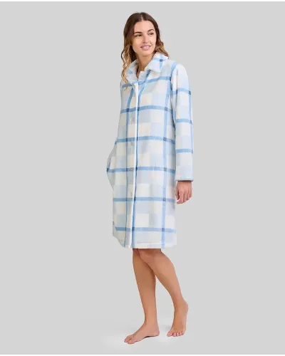 Woman wearing a long buttoned blue and white checked dressing gown with pockets