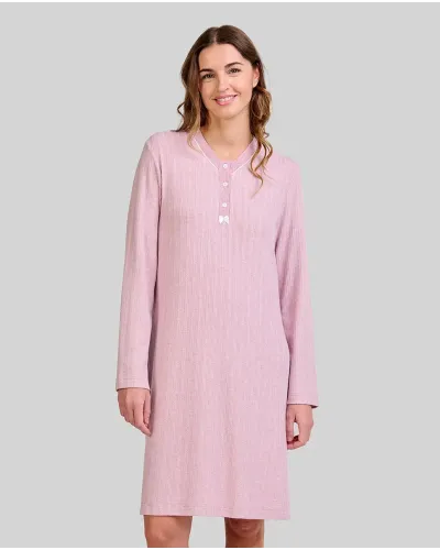 Woman wearing a long pink ribbed winter nightdress with a buttoned V-neck and bow