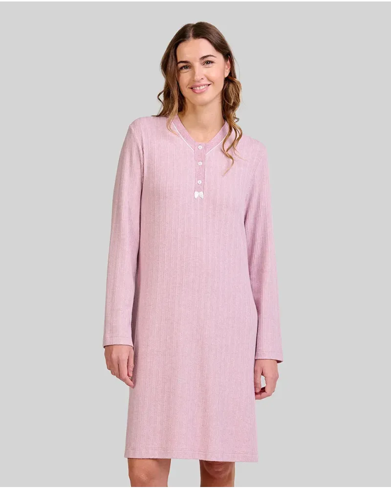 Woman wearing a long pink ribbed winter nightdress with a buttoned V-neck and bow
