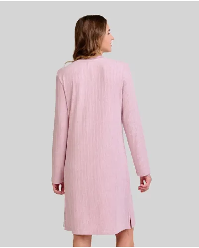 Woman wearing a long pink ribbed winter nightdress with a buttoned V-neck and bow