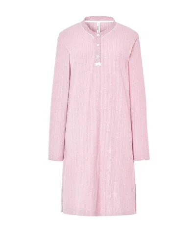 Woman wearing a long pink ribbed winter nightdress with a buttoned V-neck and bow