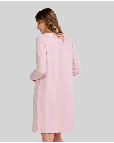 Woman poses in a pink long-sleeved nightdress with a breast pocket and buttoned neckline, ideal for sleeping.