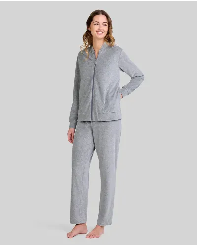 Woman posing in a grey pyjama set with a zip-up jacket with pockets and matching trousers.