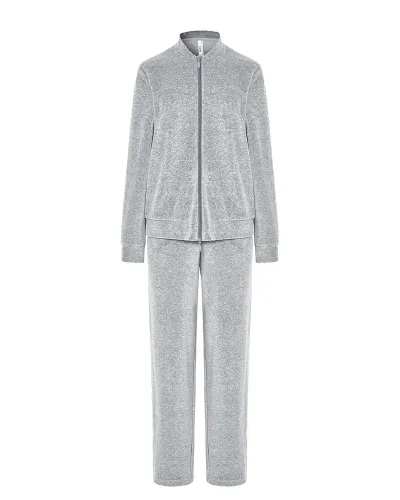 Woman posing in a grey pyjama set with a zip-up jacket with pockets and matching trousers.