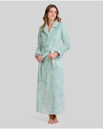 Woman wears a lovely long dressing gown in soft green Jacquard, buttoned with a lapel collar, belt and side pockets.