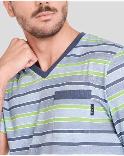 Man wears short striped summer pyjama top and blue shorts.