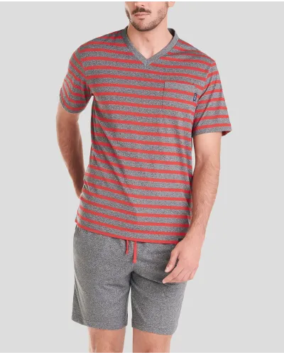 Man wearing red striped short-sleeved summer pyjamas and grey shorts