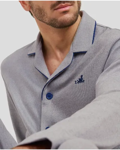 Man in grey plain winter pyjamas with blue piping on the collar