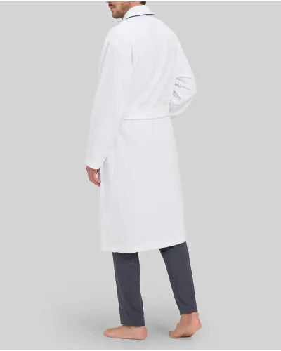 Man in white bathrobe with dinner jacket collar and blue piping and pockets