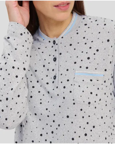 Woman with long-sleeved winter pyjamas in grey taupe with polka dot pattern